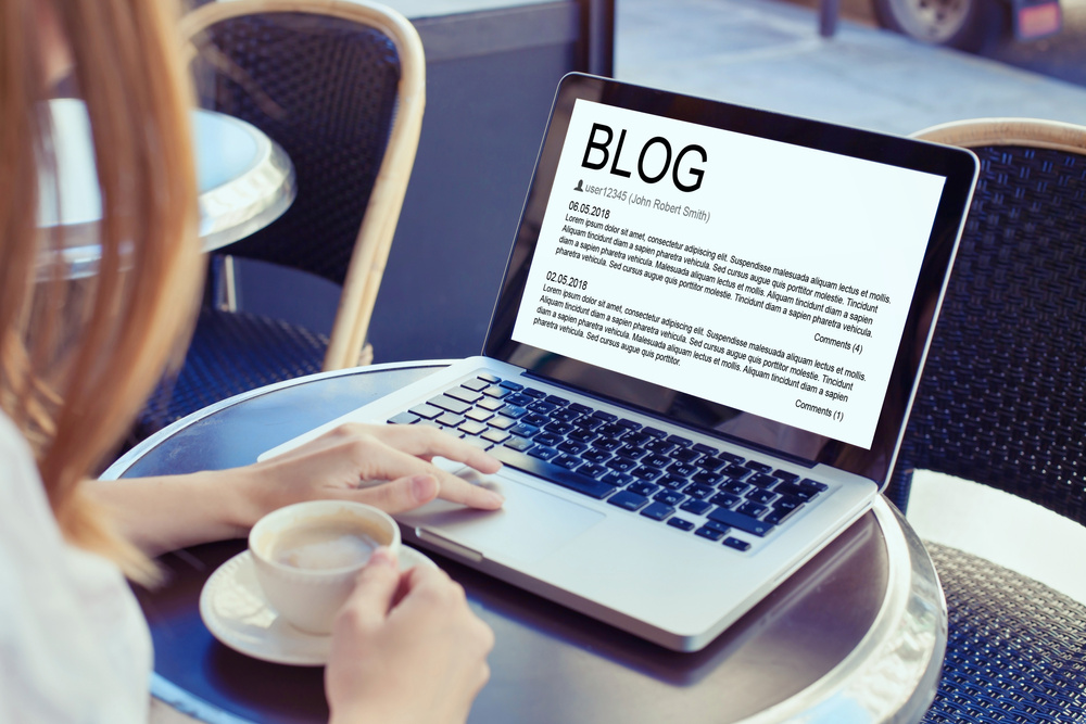 Blog concept, woman blogger reading and writing online.